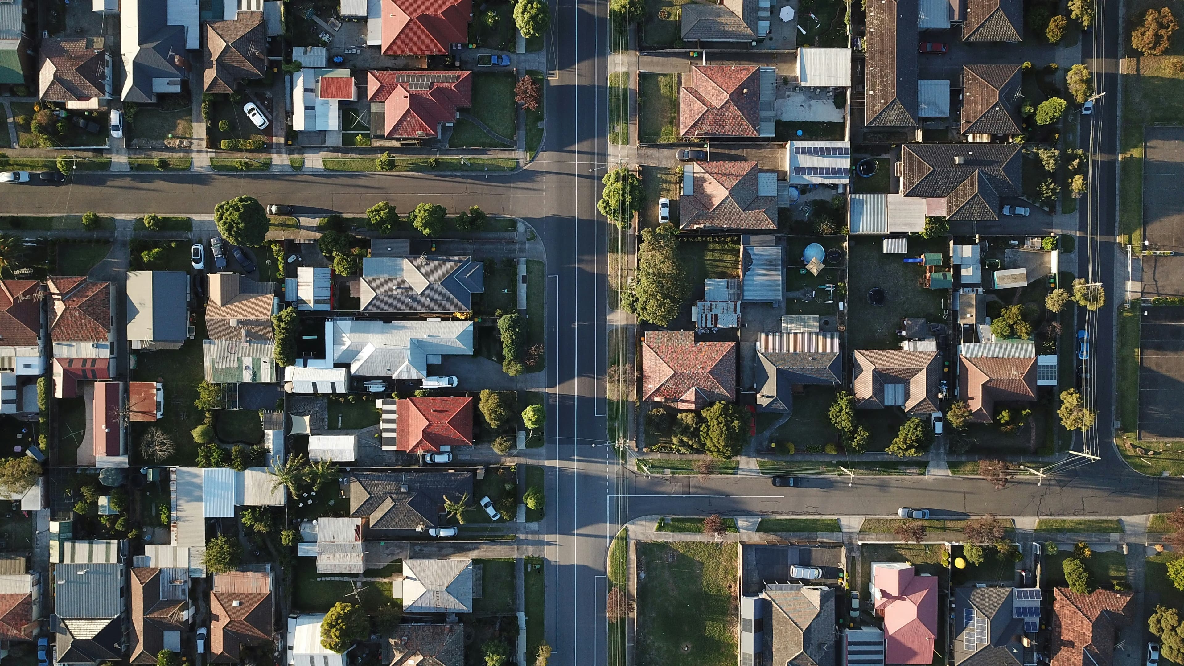 Aerial view of a Calgary suburban neighbourhood with detached homes and green space.