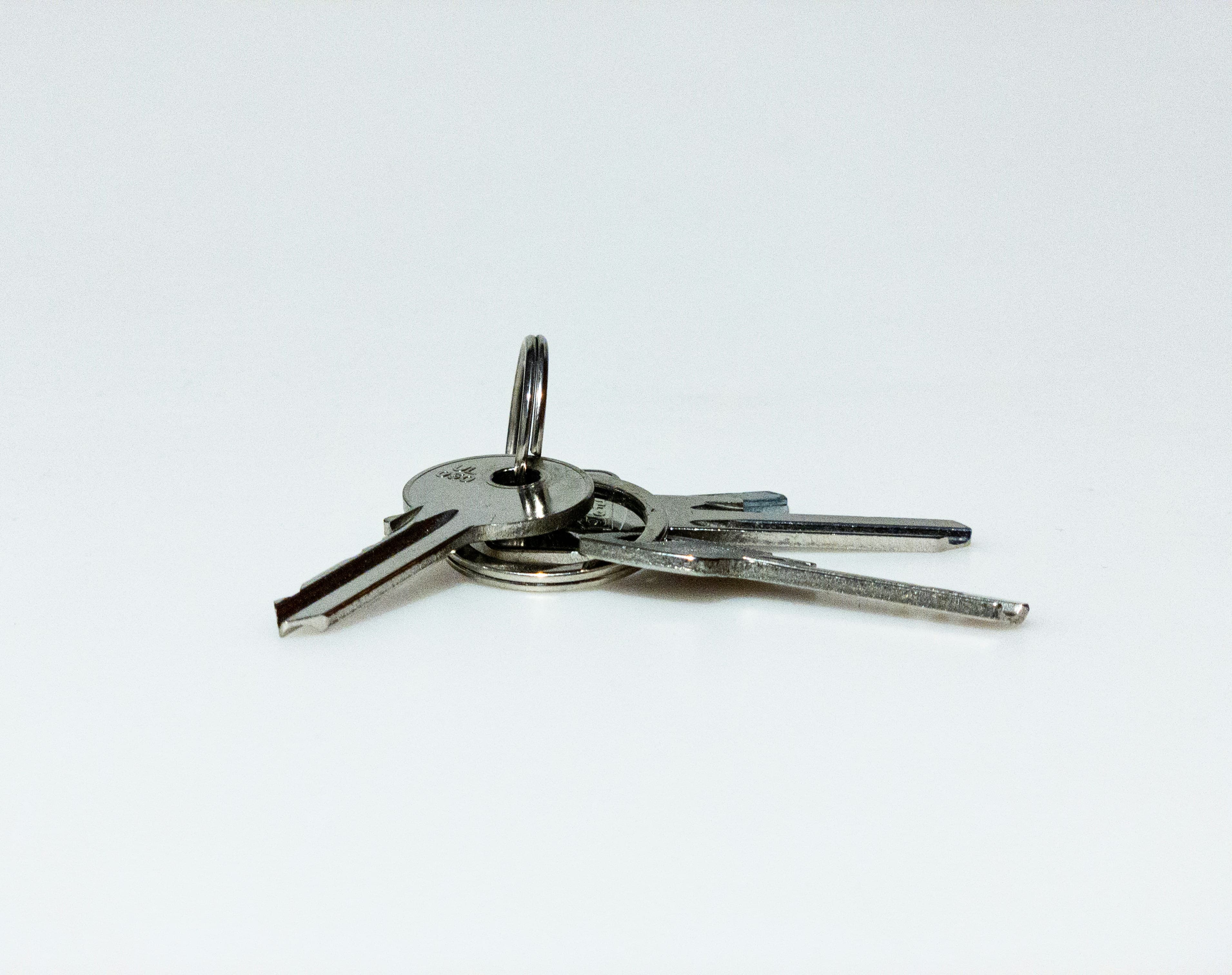 A set of house keys held in a hand, representing a new home purchase in Alberta.